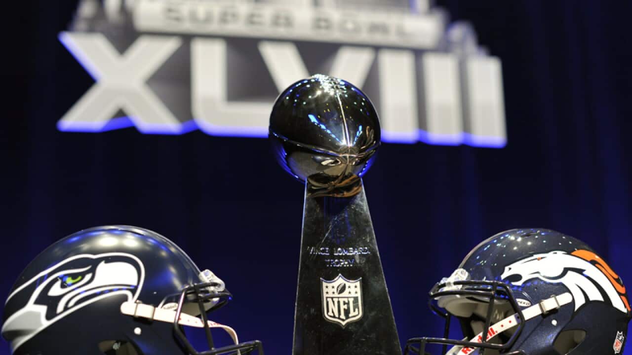 The Superbowl trophy and team helmets on display