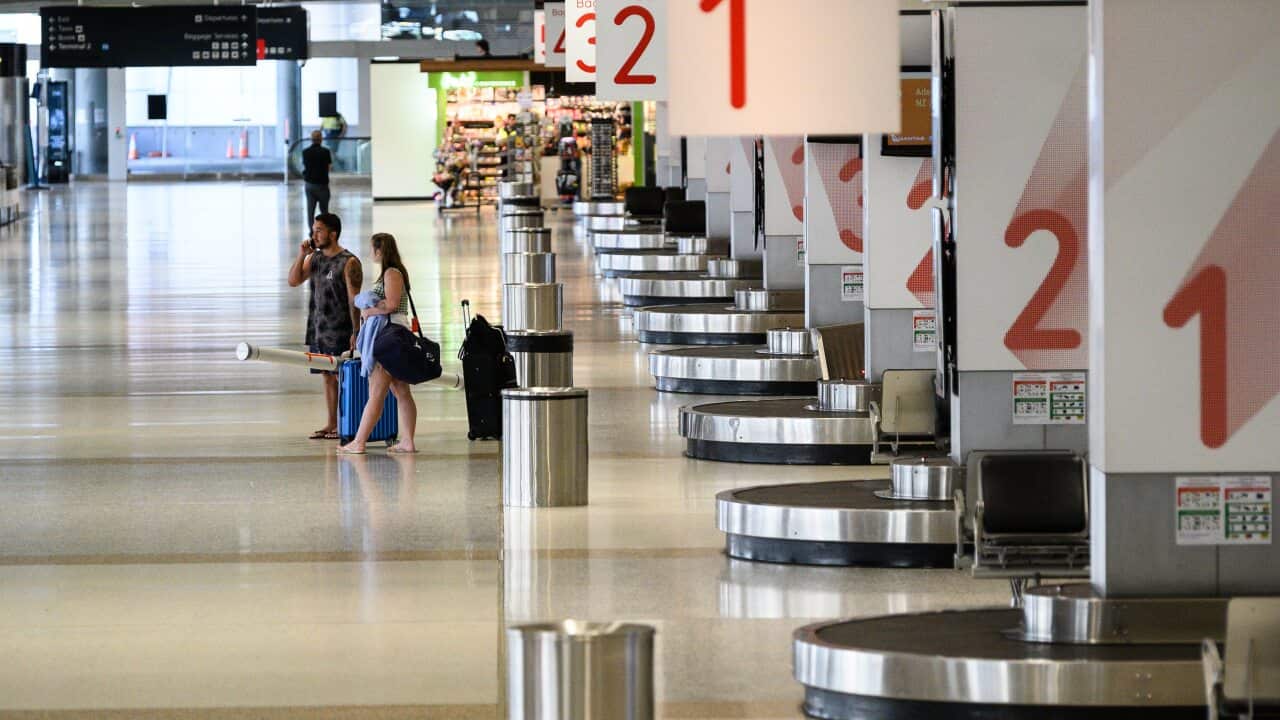 Passengers in an usually quiet baggage arrivals area at Sydney Domestic Airport in March.