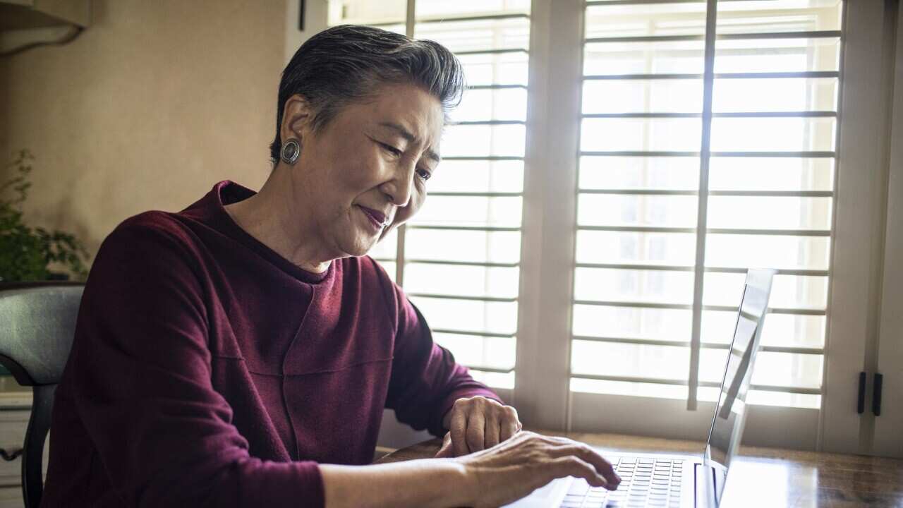 Senior woman using laptop computer at home