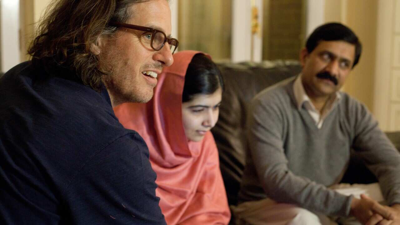 (L-r) Davis Guggenheim, Malala Yousafzai and her father, Ziauddin Yousafzai, in Birmingham, England. The Oscar-winning director has a new documentary out on the teen Nobel Peace Prize winner, whom he considers the most remarkable person he has met.
