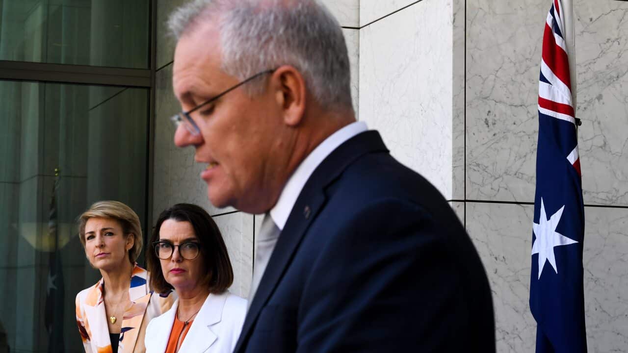 Social Services Minister Anne Ruston and Employment Minister Michaelia Cash listen to Prime Minister Scott Morrison on Tuesday