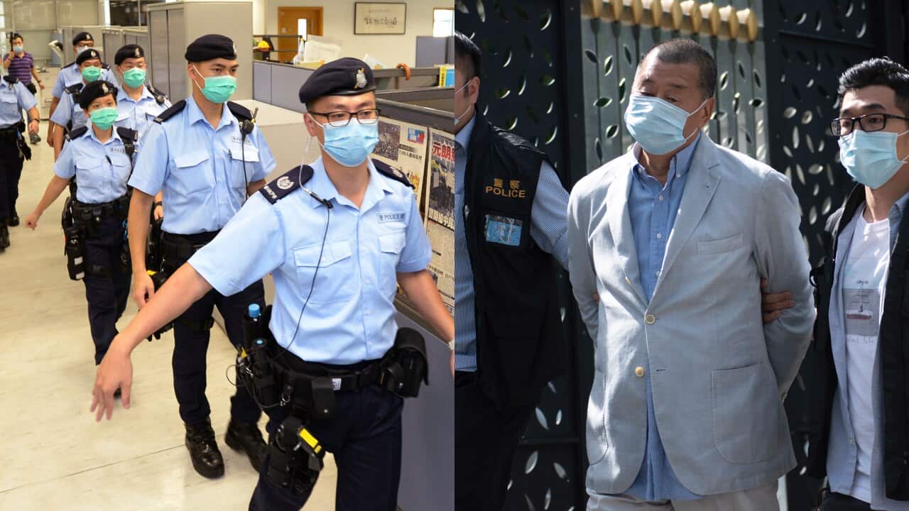 Police officers take action inside Apple Daily headquarters as Hong Kong media tycoon and founder Jimmy Lai is arrested.