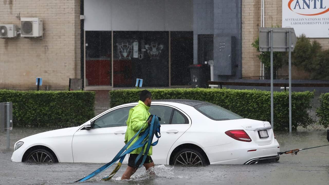 car is towed from a flooded road in Oxley, Saturday, February 26, 2022.