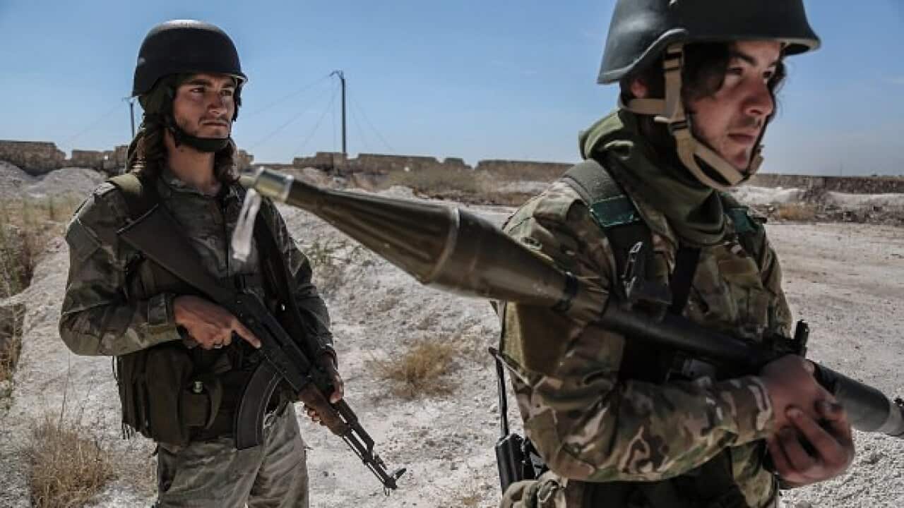 Soldiers of the Sham Brigade of the National Liberation Front of Syria (NFL) patrol the front line.