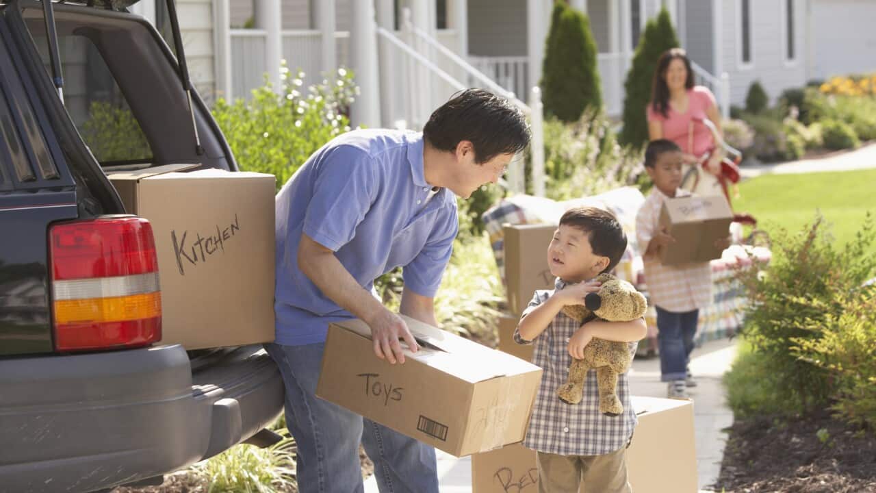 SG Moving Interstate - family packing moving boxes into car