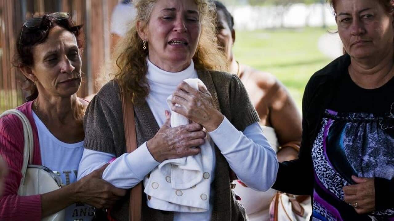 Grieving relatives of passengers leave the morgue