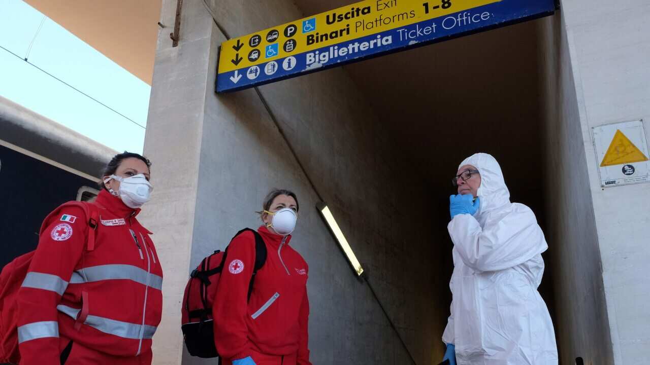Personnel checked for passengers arriving on the Intercity Night train from Milan during the emergency lockdown.
