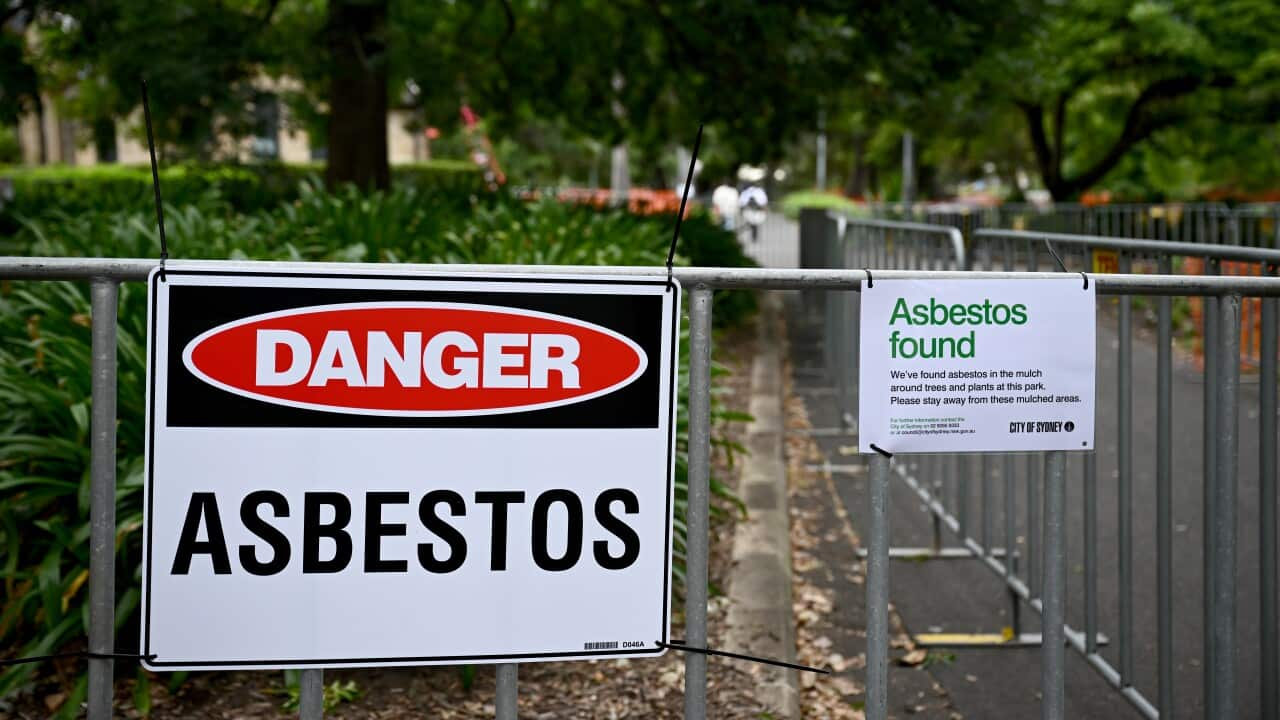 A general view of a park with an asbestos warning sign.