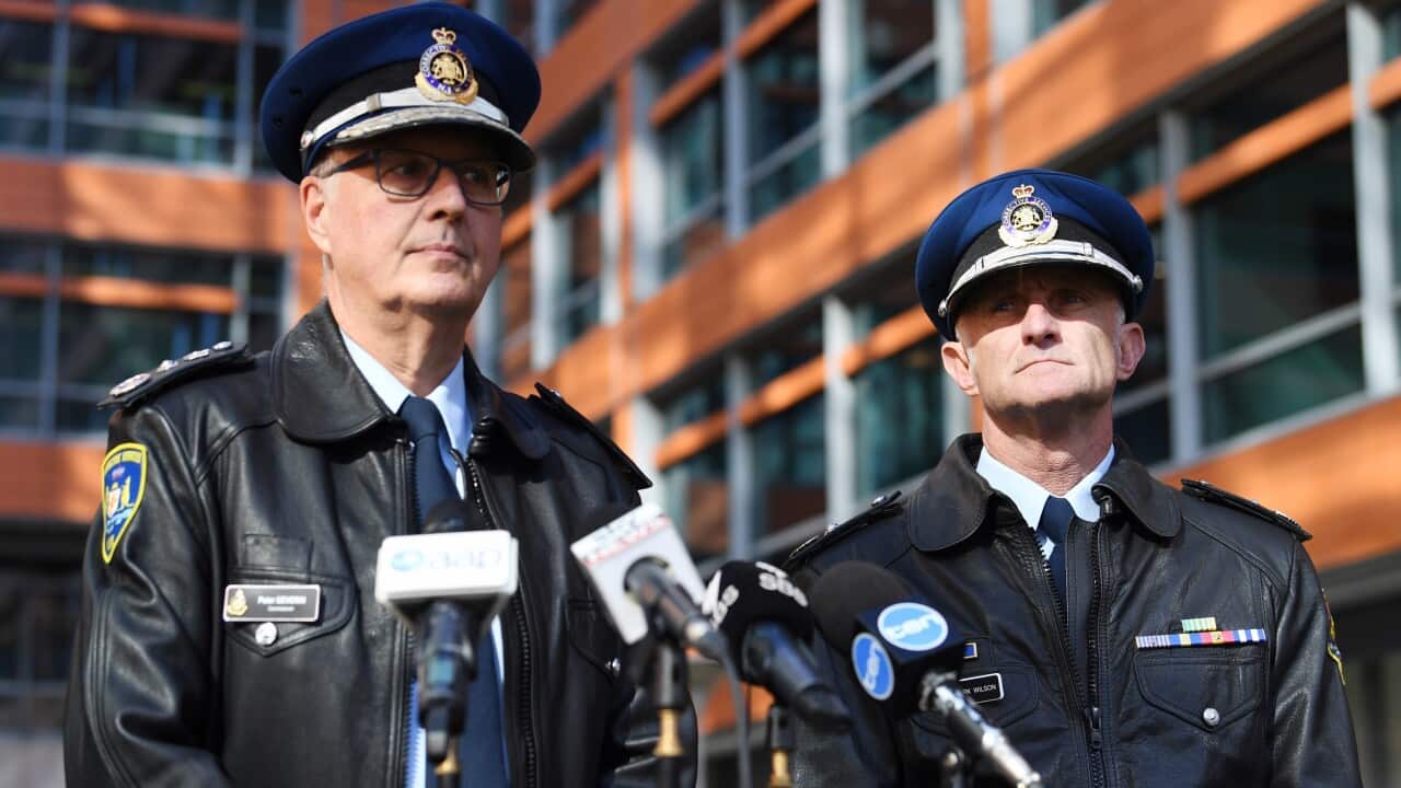Corrective Services NSW Commissioner Peter Severin is silhouetted as he answers a question during a press conference 