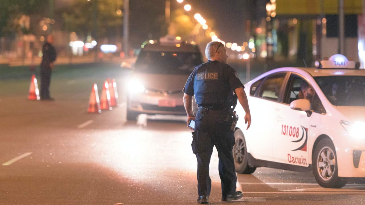 Police cordon off the intersection of Stuart Highway and McMinn Street where a gunman was apprehended in Darwin, Tuesday, June 4, 2019