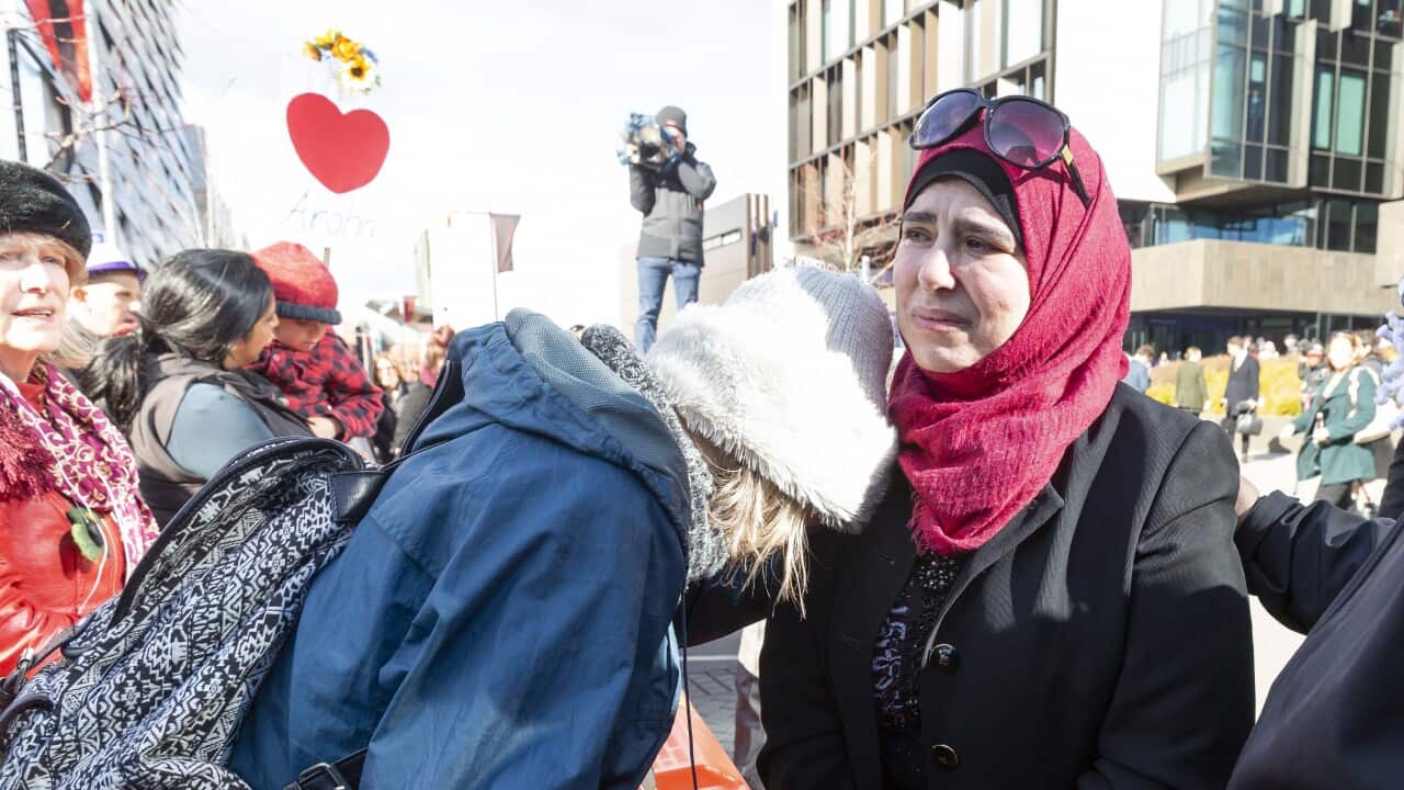 Survivors celebrate with supporters outside the High Court in Christchurch, New Zealand. 