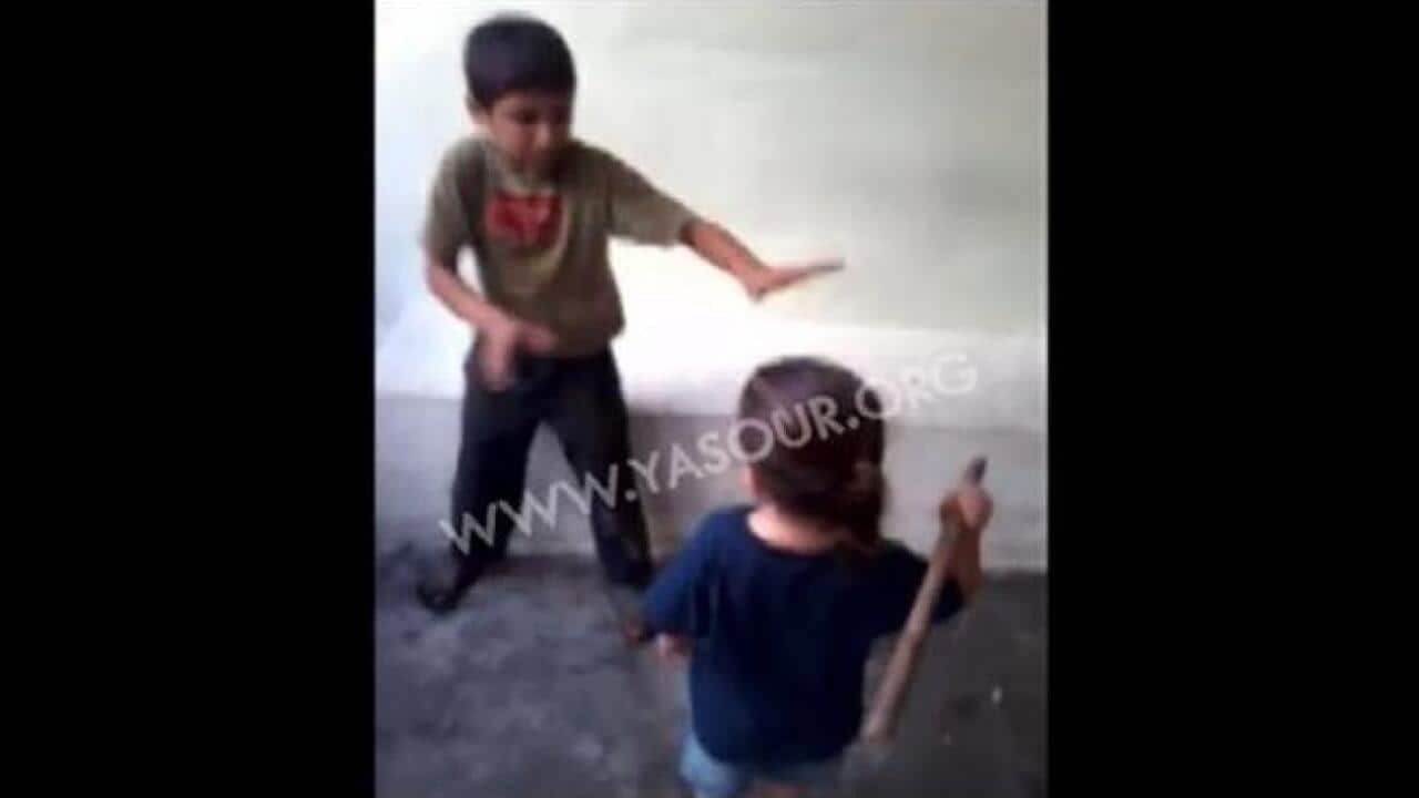 Lebanon has ordered an investigation into horrific video footage that's gone viral on the internet showing a small child beating a boy as adults around them encourage him. (Screenshot: YouTube)