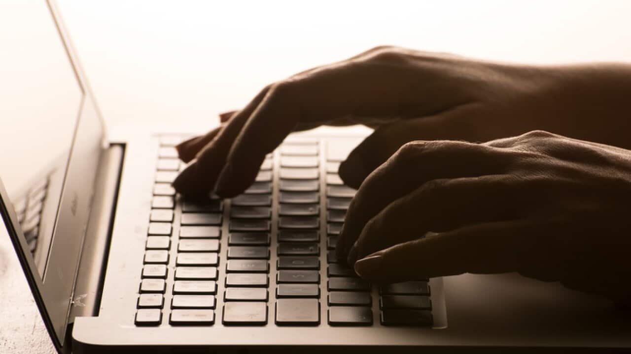 A woman's hands on a laptop keyboard