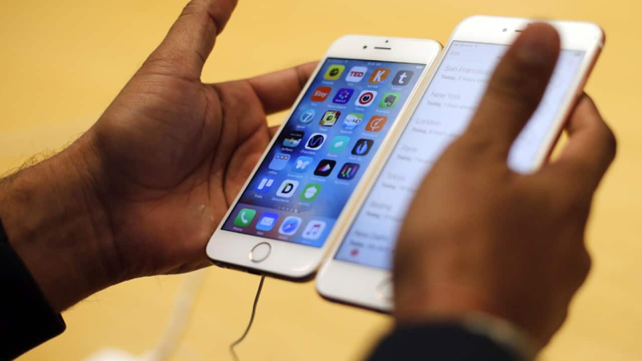 A customer tries out a new Apple iPhone 6S