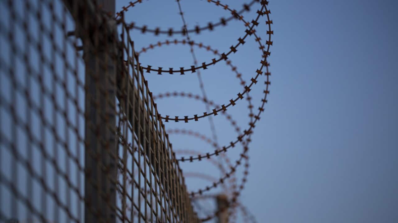 Coiled barbed wire fence attached to mesh fence in Melbourne, Victoria. (Getty).