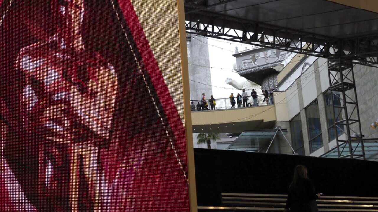 Spectators try to get a glance of the red carpet