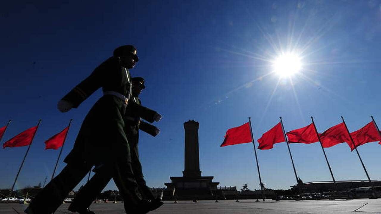 Paramilitary police march past the Monum