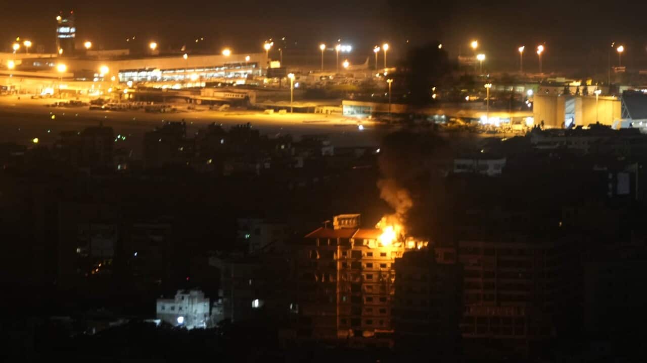 Flames rise from a building hit by an Israeli airstrike near Rafik Hariri International airport (AAP)