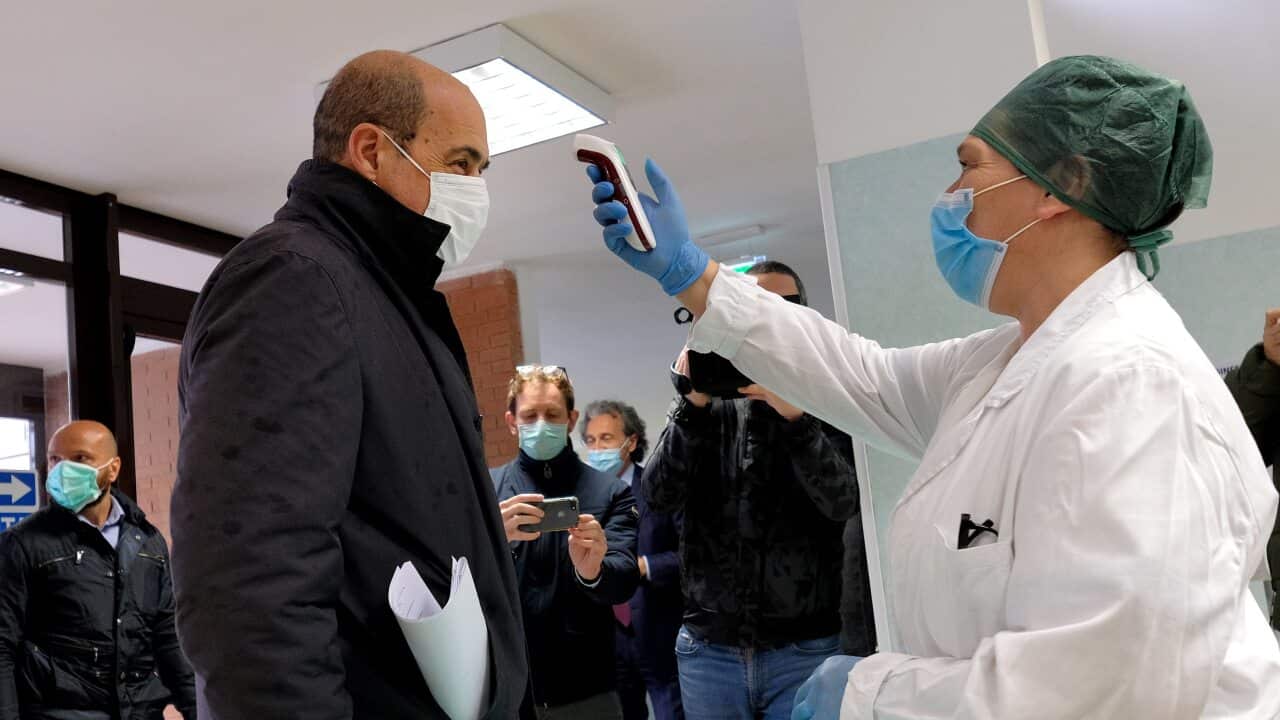 Temperature checking of elderly residents in Italy.