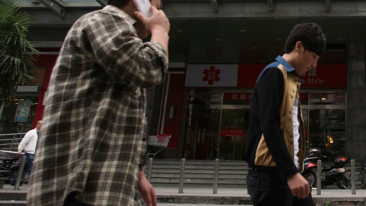A pedestrian using his mobile phone in Hong Kong