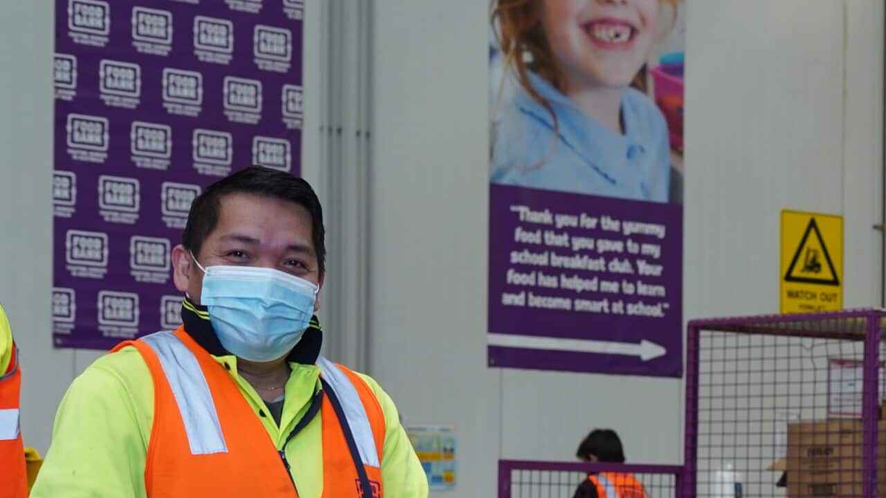 Foodbank workers distributing boxes of donated food.