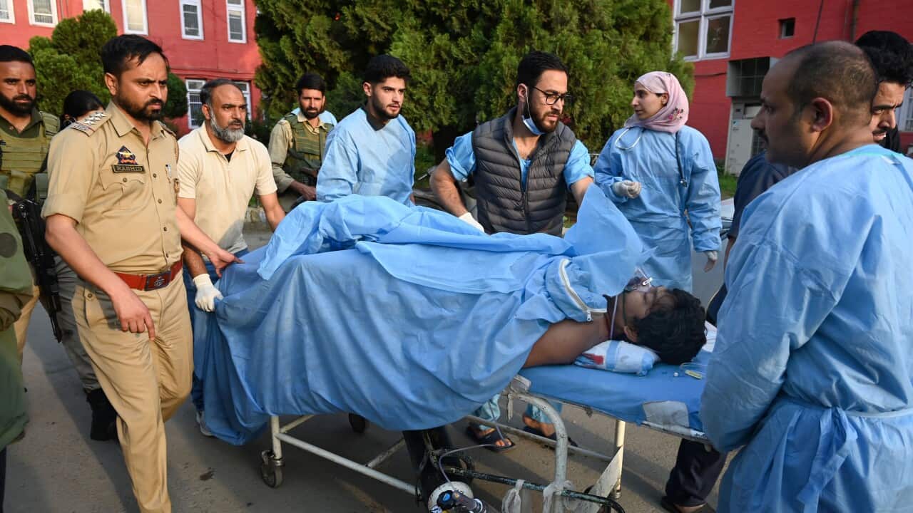 Paramedics carry an injured tourist at a hospital