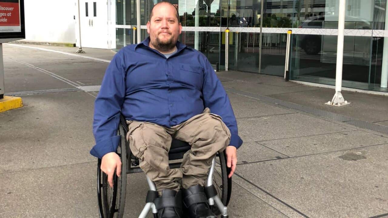 A man who uses a wheelchair is pictured at an airport.