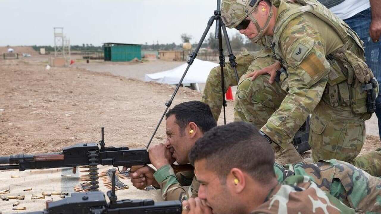 An Australian Army soldier coaches Iraqi Security Forces.