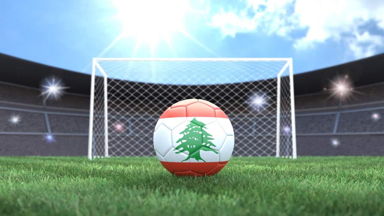 Soccer ball in flag colors on a bright sunny stadium background. Lebanon.