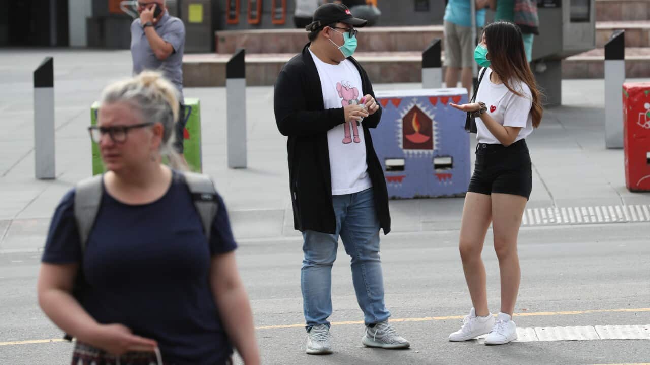 People wear face masks in the CBD of Melbourne following a double digit increase in coronavirus cases.