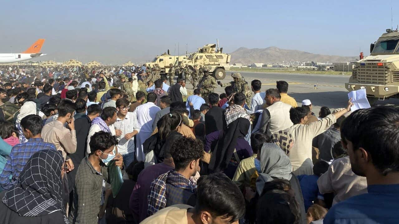 US soldiers stand guard along a perimeter at the international airport in Kabul, Afghanistan on 16 August 16,2021.