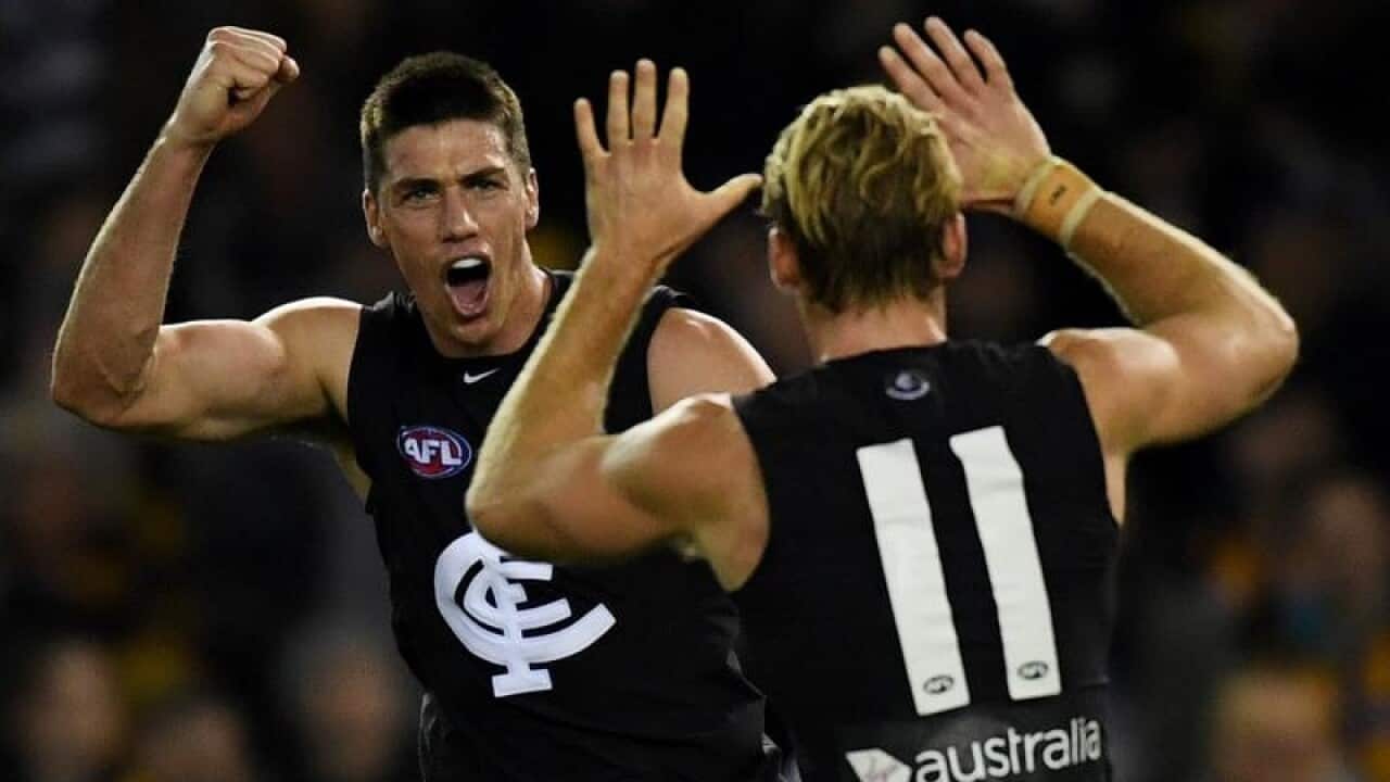 Carlton players celebrate.