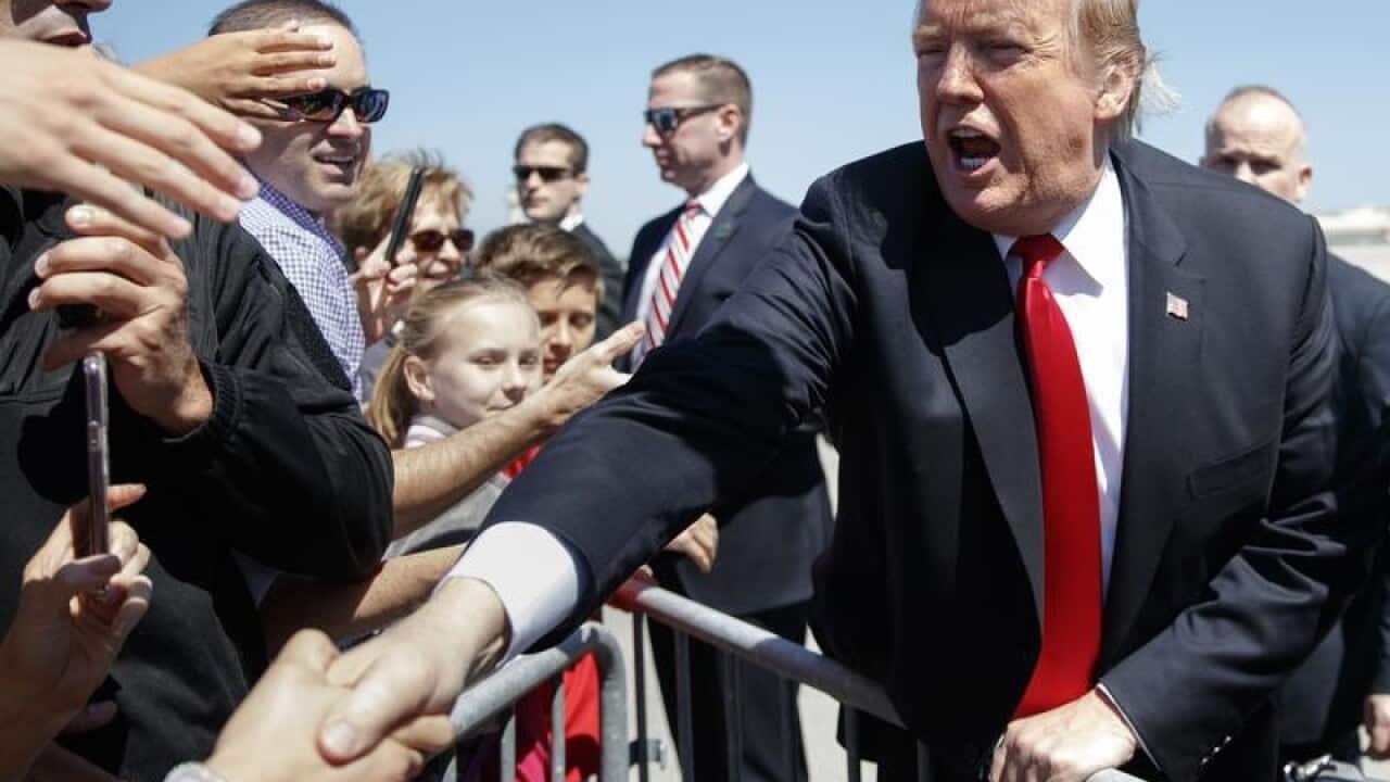President Trump greets supporters at the airport in Palm Beach