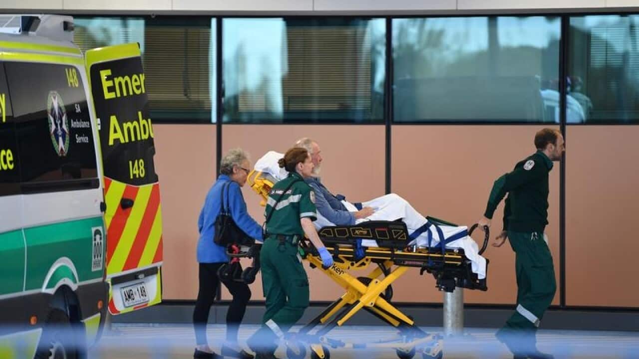 Patient on ambulance gurney arriving at hospital.