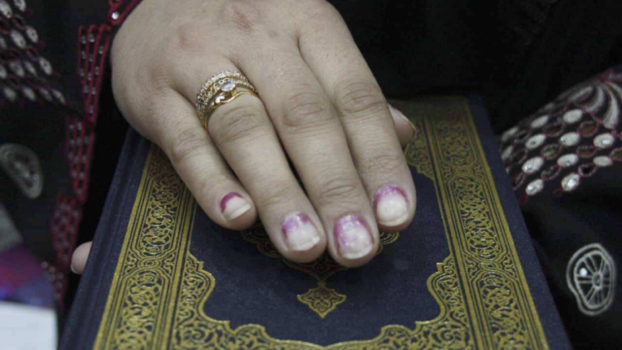 An Afghan lawmaker takes an oath on the Koran