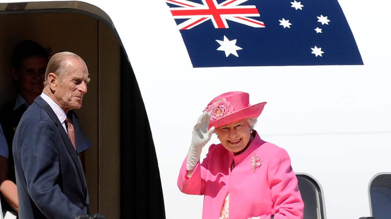 Britain's Queen Elizabeth II, right, and her husband Prince Philip, board a plane flying to Perth from Melbourne airport, October 2011.