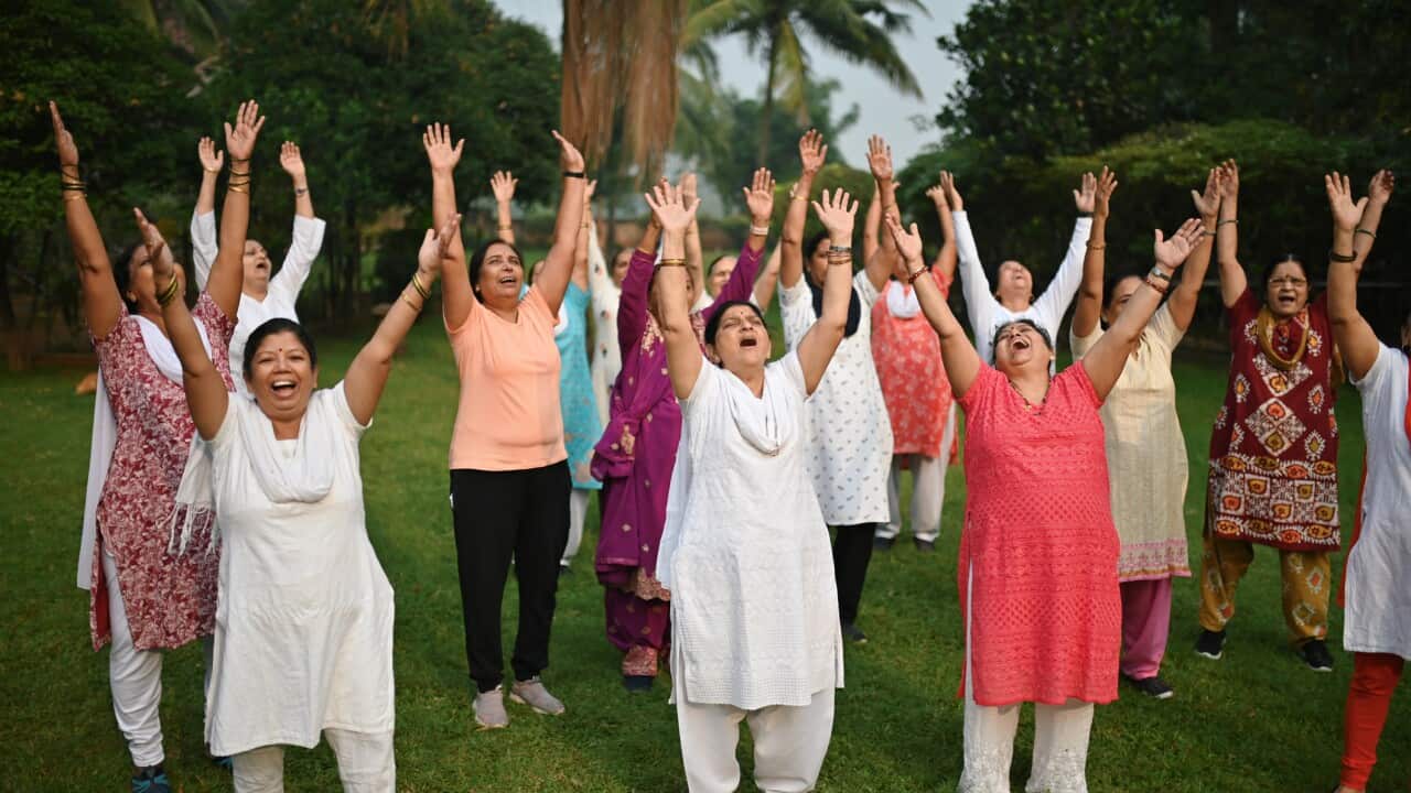 Senior women doing laughing exercises in a park