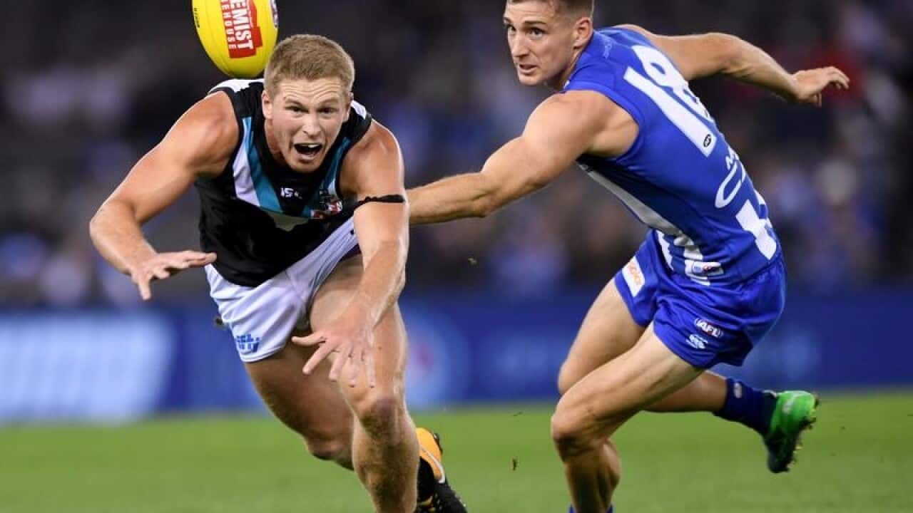 Tom Clurey of the Power and Shaun Atley of the Kangaroos contest.