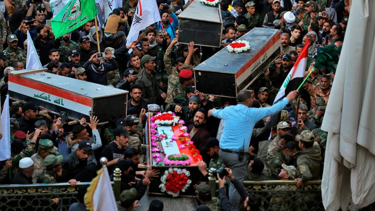 Mourners carry the coffins of Iran-backed fighters killed in a US airstrike in Qaim, during their funeral in Iraq.