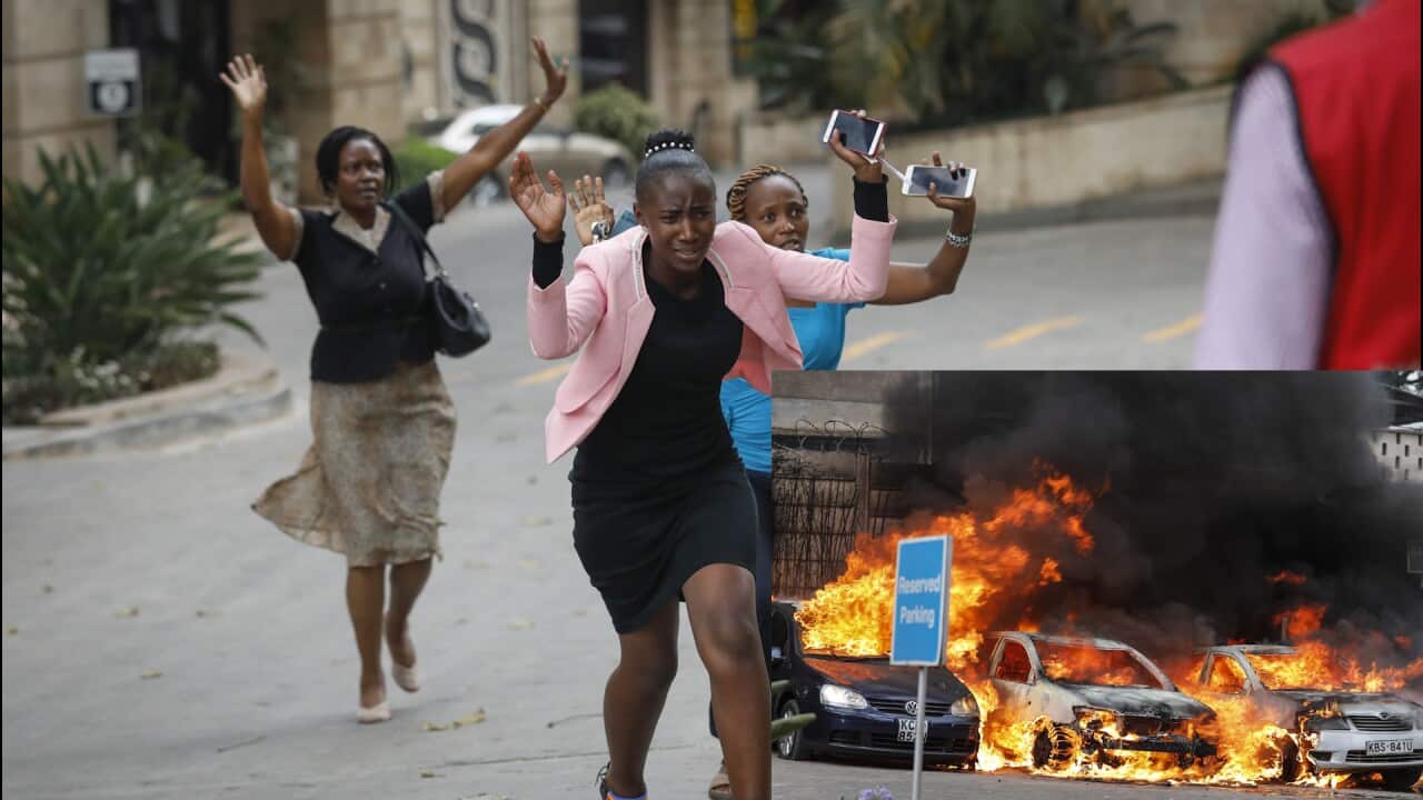 Women raise their hands as they make a run for the rescue workers, during an ongoing gunfire and explosions in Nairobi, Kenya.