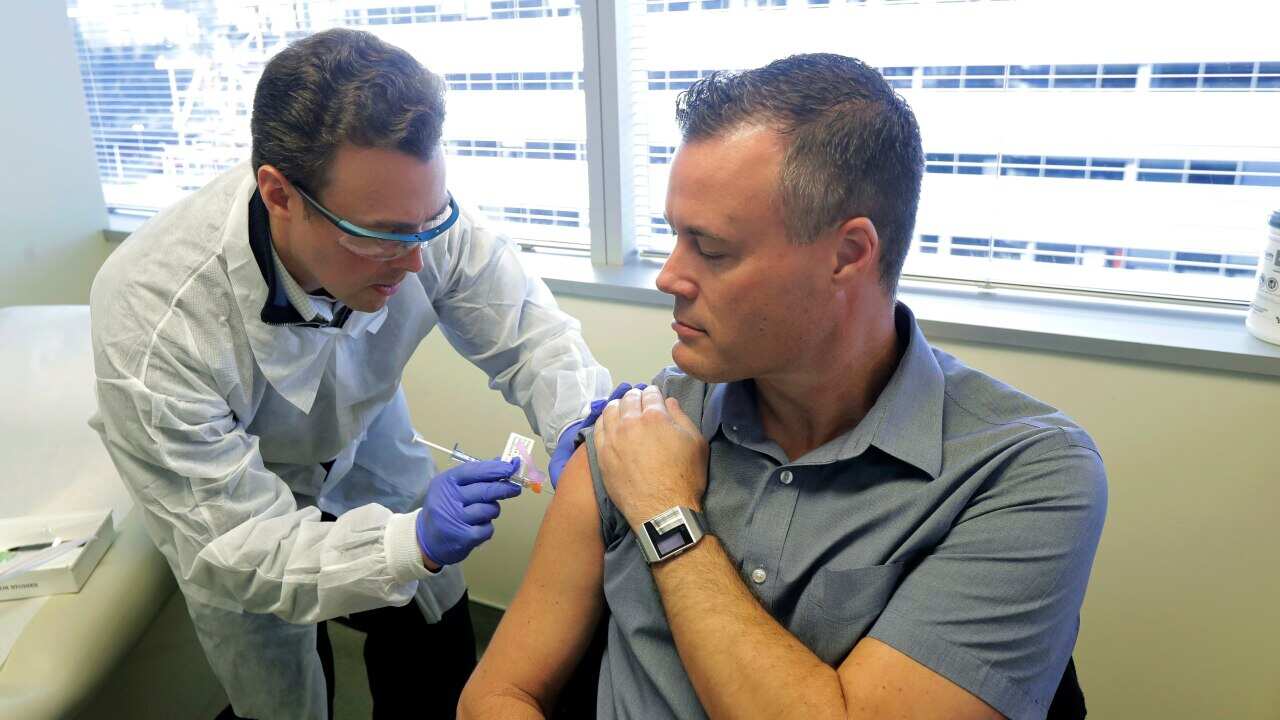 Pharmacist Michael Witte gives Neal Browning a shot