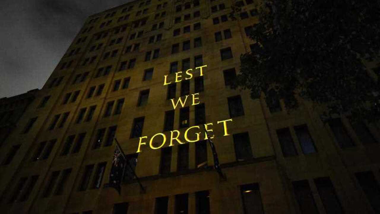 The words Lest We Forget are projected onto a building during the Anzac Day Dawn service at Martin Place in Sydney, Wednesday, April 25, 2018.