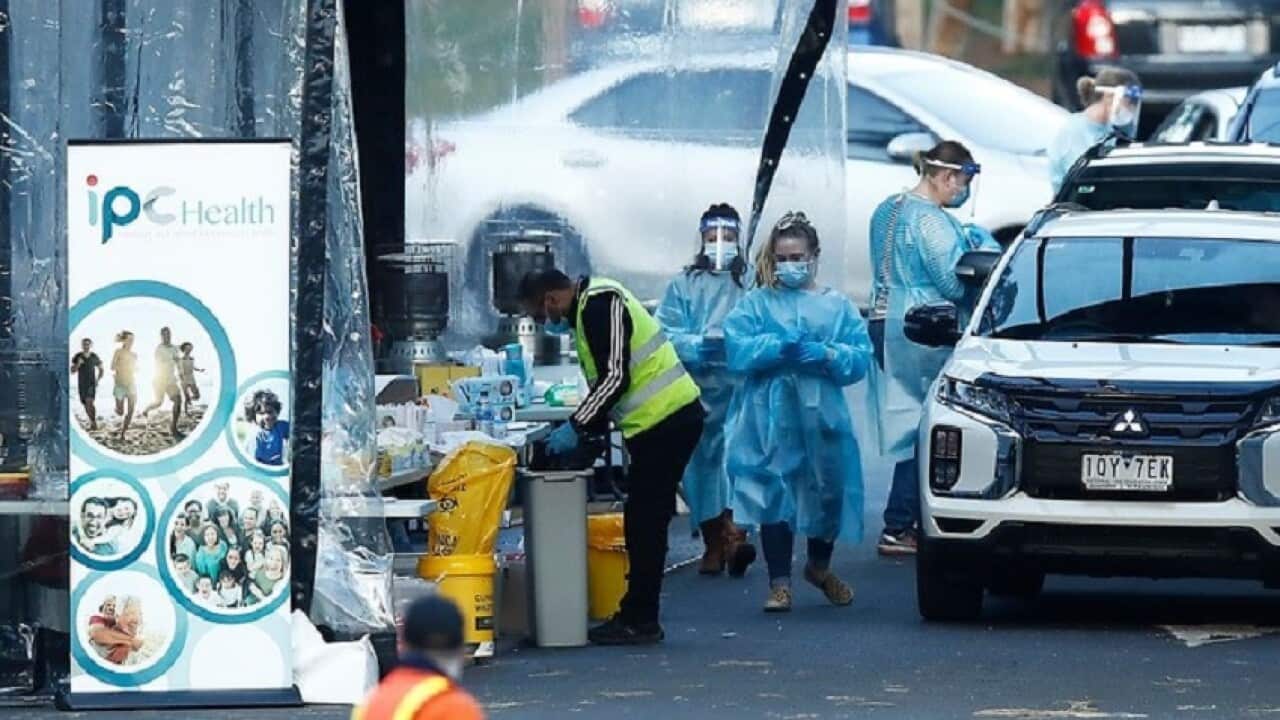COVID-19 testing staff are seen at a pop-up testing site