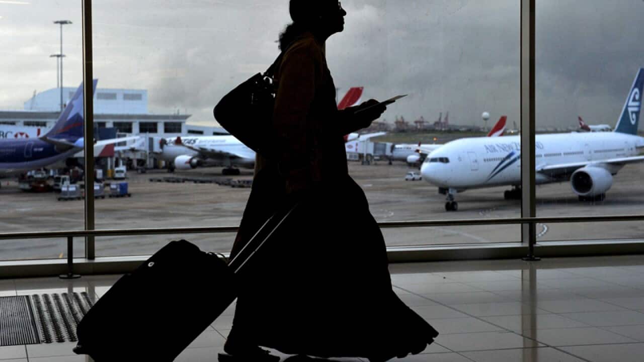 A passenger walks through Sydney Airport.