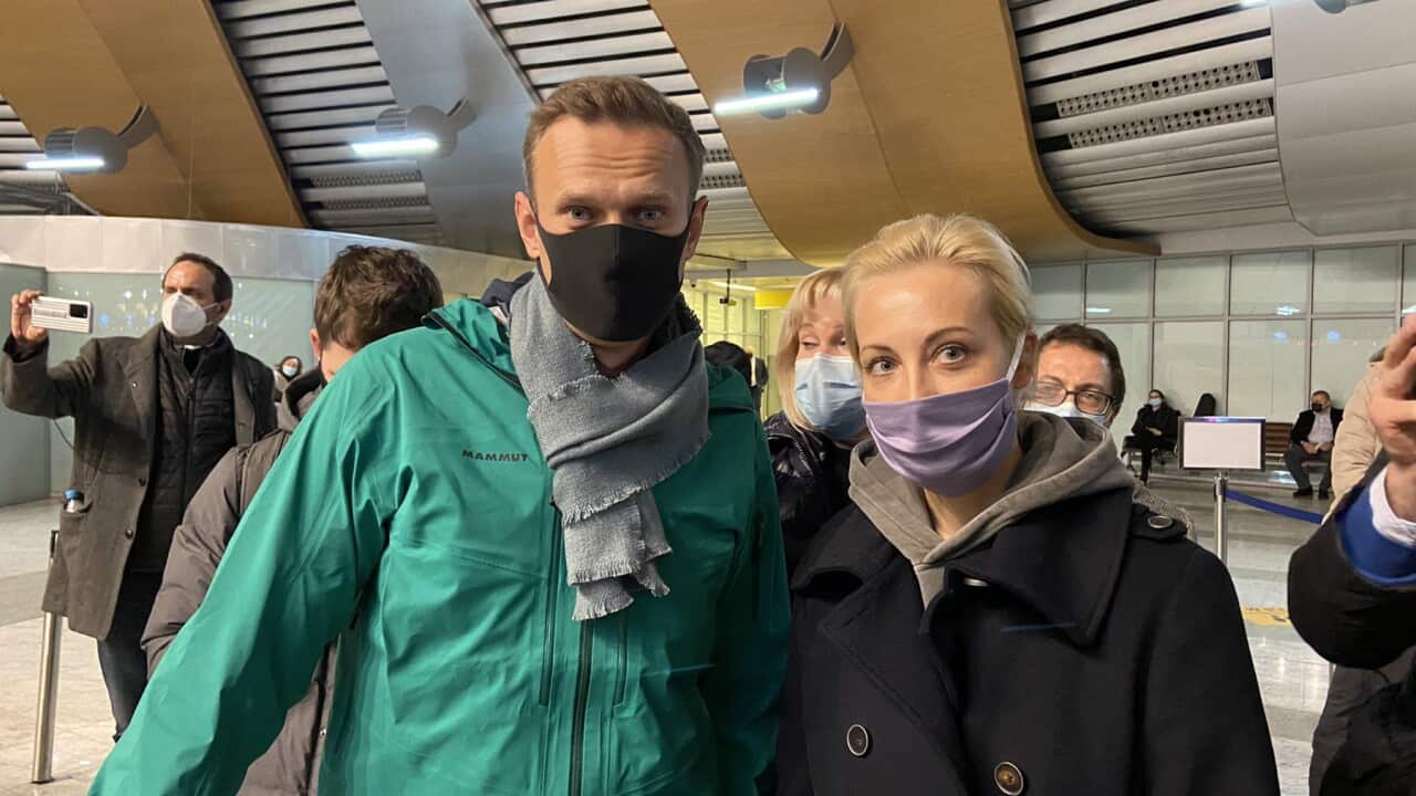Alexei Navalny and his wife Yulia are passing through airport border control
