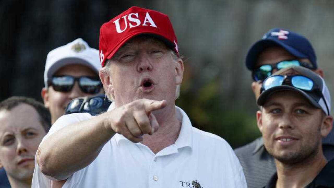 President Donald Trump speaks as he meets with members of the U.S. Coast Guard, who he invited to play golf, at Trump International Golf Club, Friday, Dec. 29, 2017, in West Palm Beach.