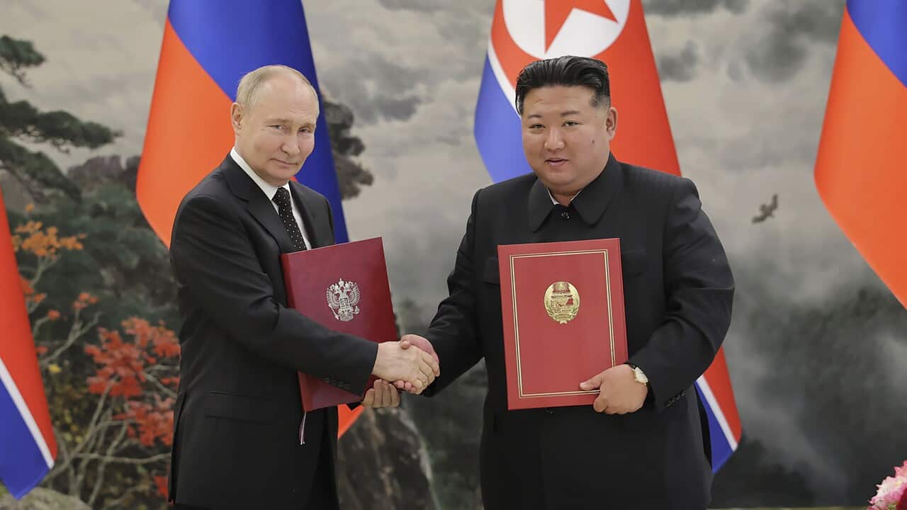Vladimir Putin (left) is shaking hands with Kim Jong-un.
