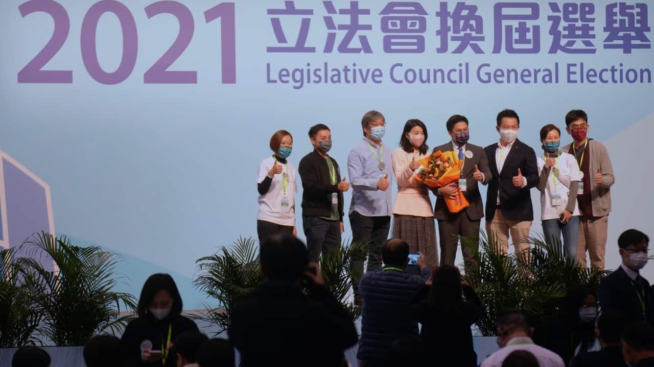 Pro-Beijing candidate Kenneth Fok ( fourth from right) with wife Guo Jingjing (fourth from left).