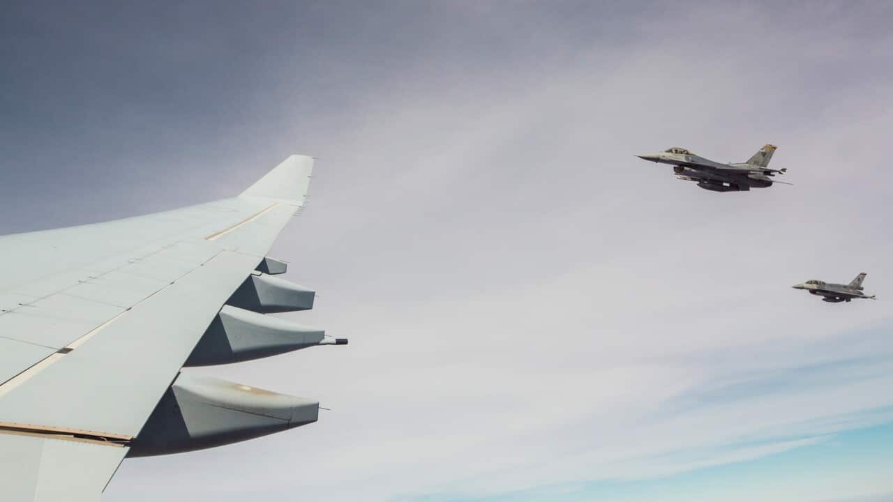 A pair of military aircraft flies over the Northern Territory during Exercise Pitch Black