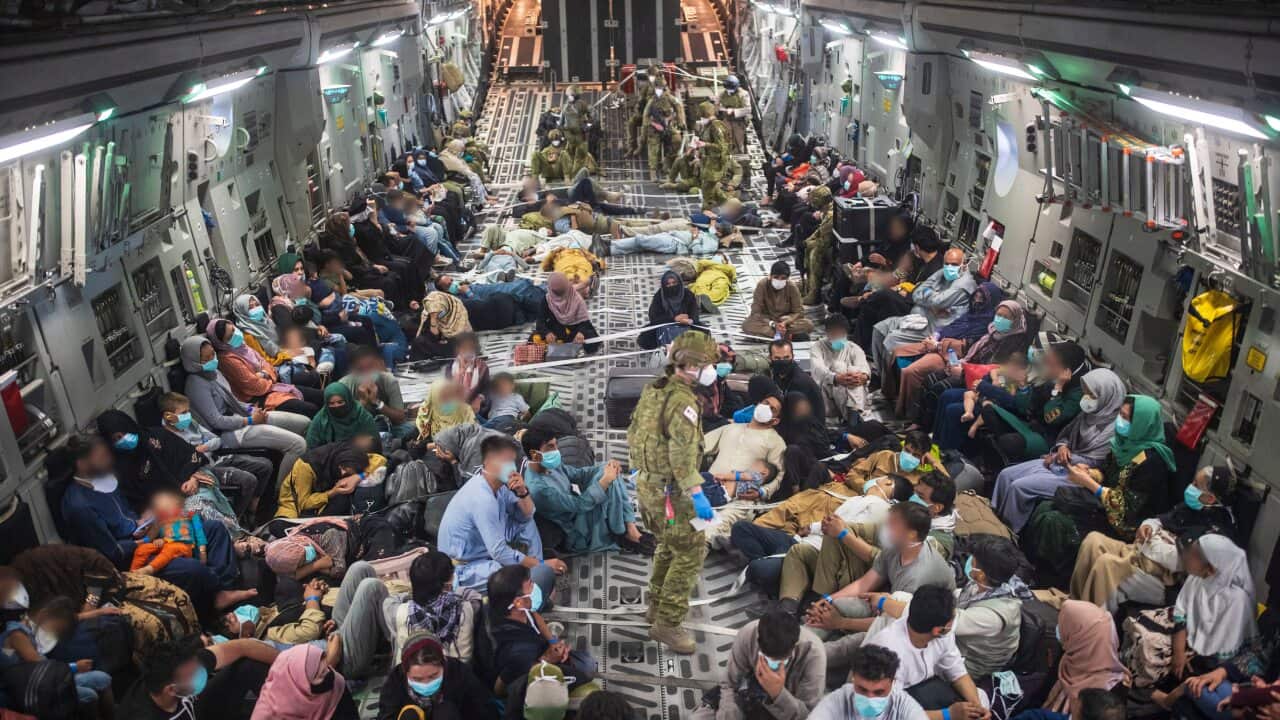 Evacuees onboard a Royal Australian Air Force C-17A Globemaster III aircraft after leaving Afghanistan.